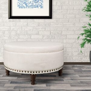 OSP Home Furnishings Augusta Round Storage Ottoman in Linen Fabric with decorative nailheads